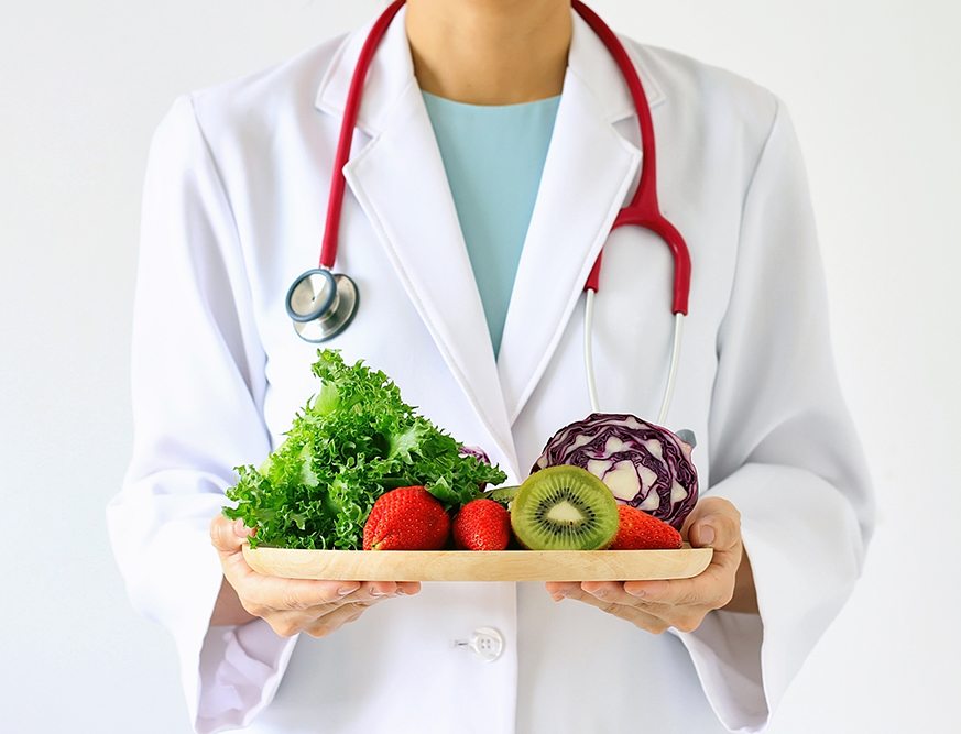 stock-photo-doctor-holding-fresh-fruit-and-vegetable-healthy-diet-nutrition-food-as-a-prescription-for-good-534096772